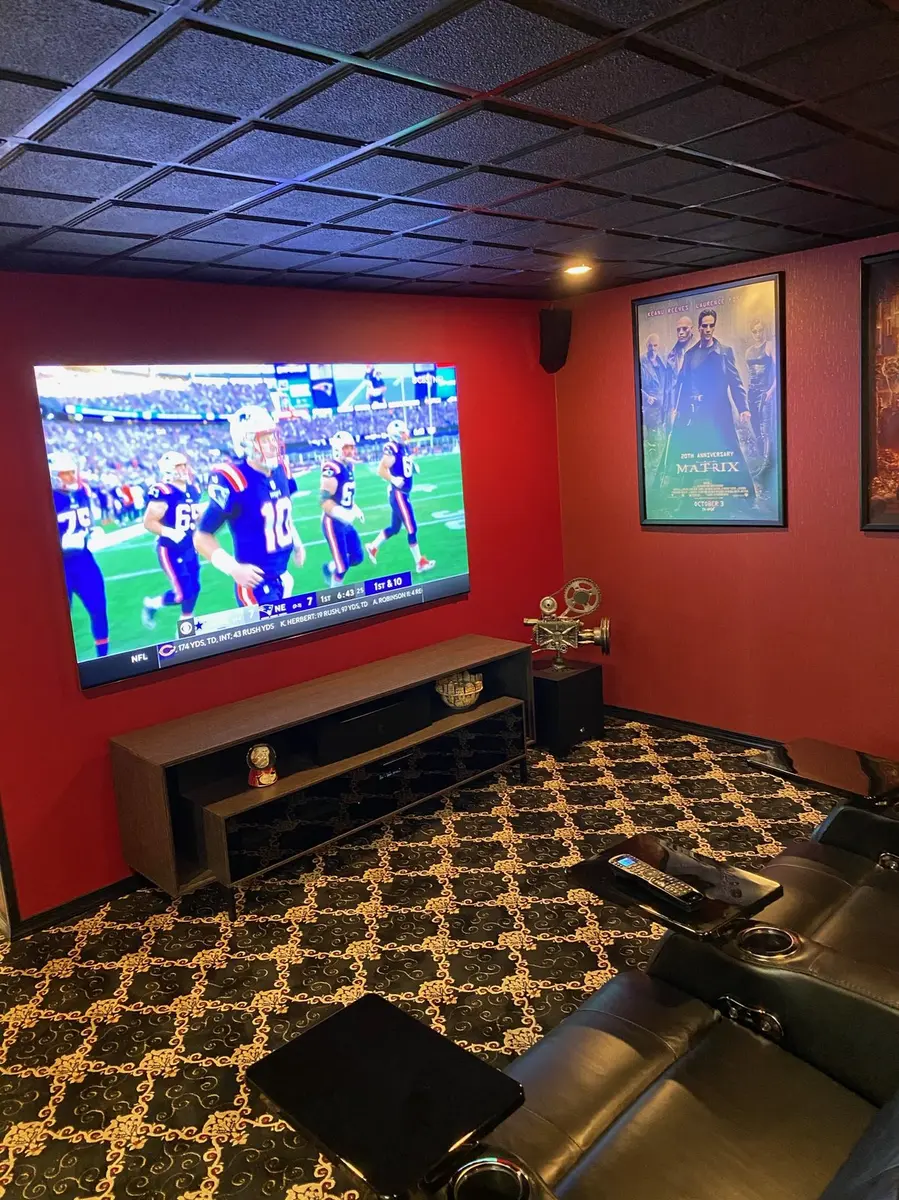 Custom basement cinema with in-ceiling speakers and theater seating