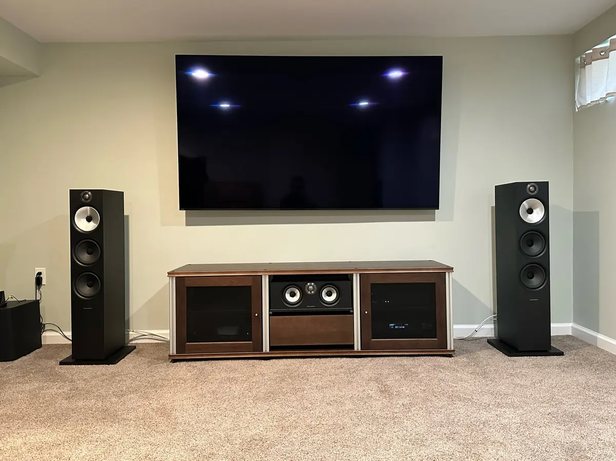 Mounted TV with Bowers and Wilkins floorstanding towers and center channel speaker